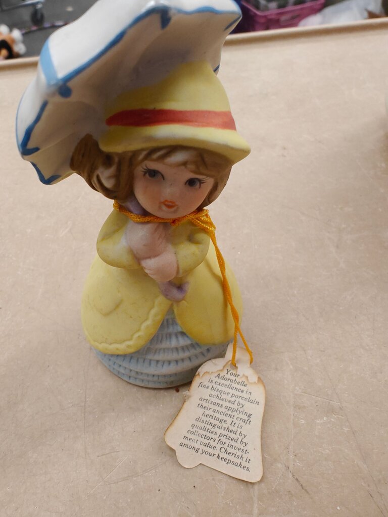 Adorable porcelain figurine with umbrella